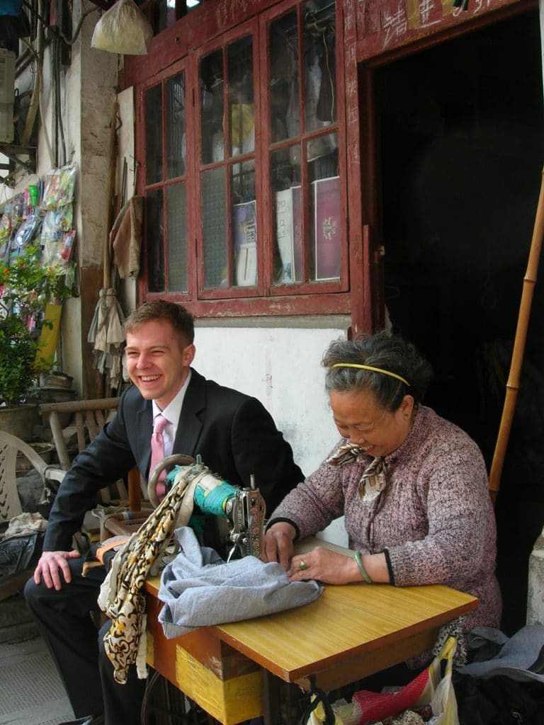 Kyle Vucko with a tailor in China